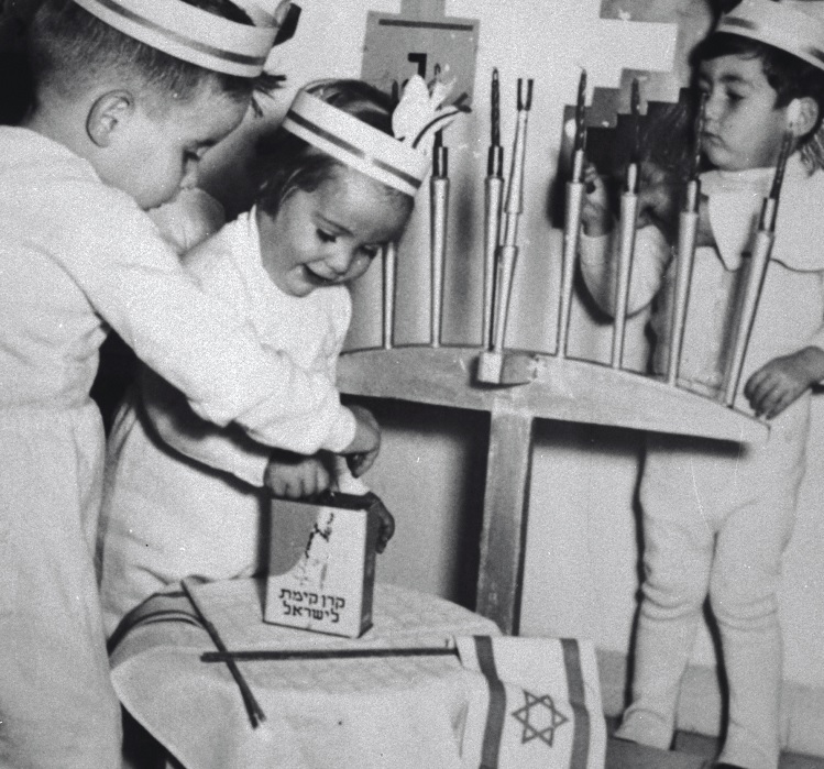 Hanukah celebrations at a Haifa Kindergarten, 1955. Photograph: Photo Aviv, KKL-JNF Photo Archive