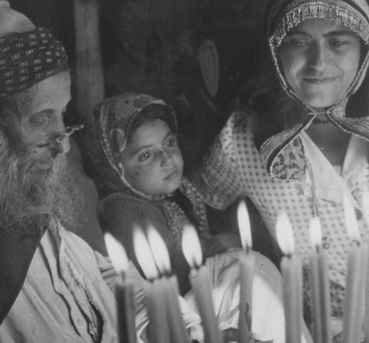 Children of Jewish families that came from Yemen light Hanukah candles in their house in Luzim (now a part of the town of Even Sapir), 1950. Photograph: Werner Brown, KKL-JNF Photo Archive.