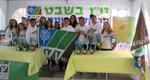 KKL-JNF National Service volunteers stand ready with herb plants to distribute to guests leaving the Knesset 67th anniversary celebrations, in honor of Tu Bishvat. Photo: KKL-JNF