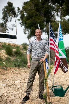 Corin Nemec plants a tree in Yad Kennedy. Leader Photography