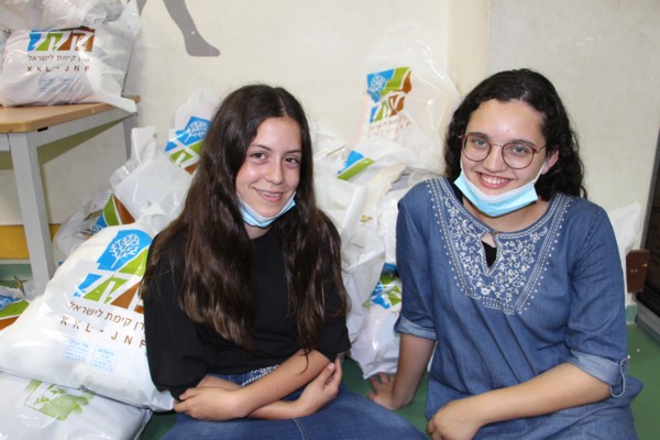 Two of the volunteers with the donation-ready care packages. (Photo: Yossi Zamir, KKL-JNF Photo Archive)
