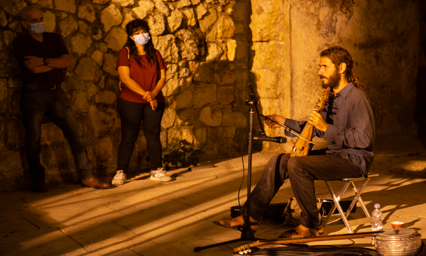 The group listens to the “oud” player. (Photo: Yoni Sheffer, KKL-JNF Photo Archive)
